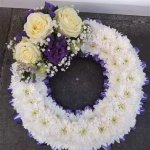 ### Based Wreath with ribbon edging and a posy   14